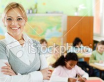 A woman is smiling in front of some other children.