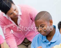 A woman and boy sitting on the ground