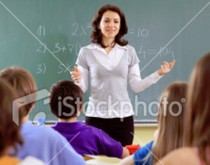 A woman standing in front of a group of people.