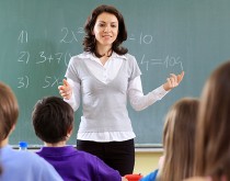 A woman standing in front of a class