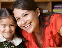 A woman and girl smiling for the camera.